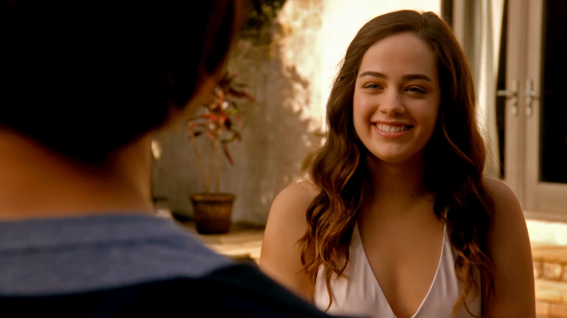 Mary Mouser is lying on a lounge chair by the pool when a man comes into th...
