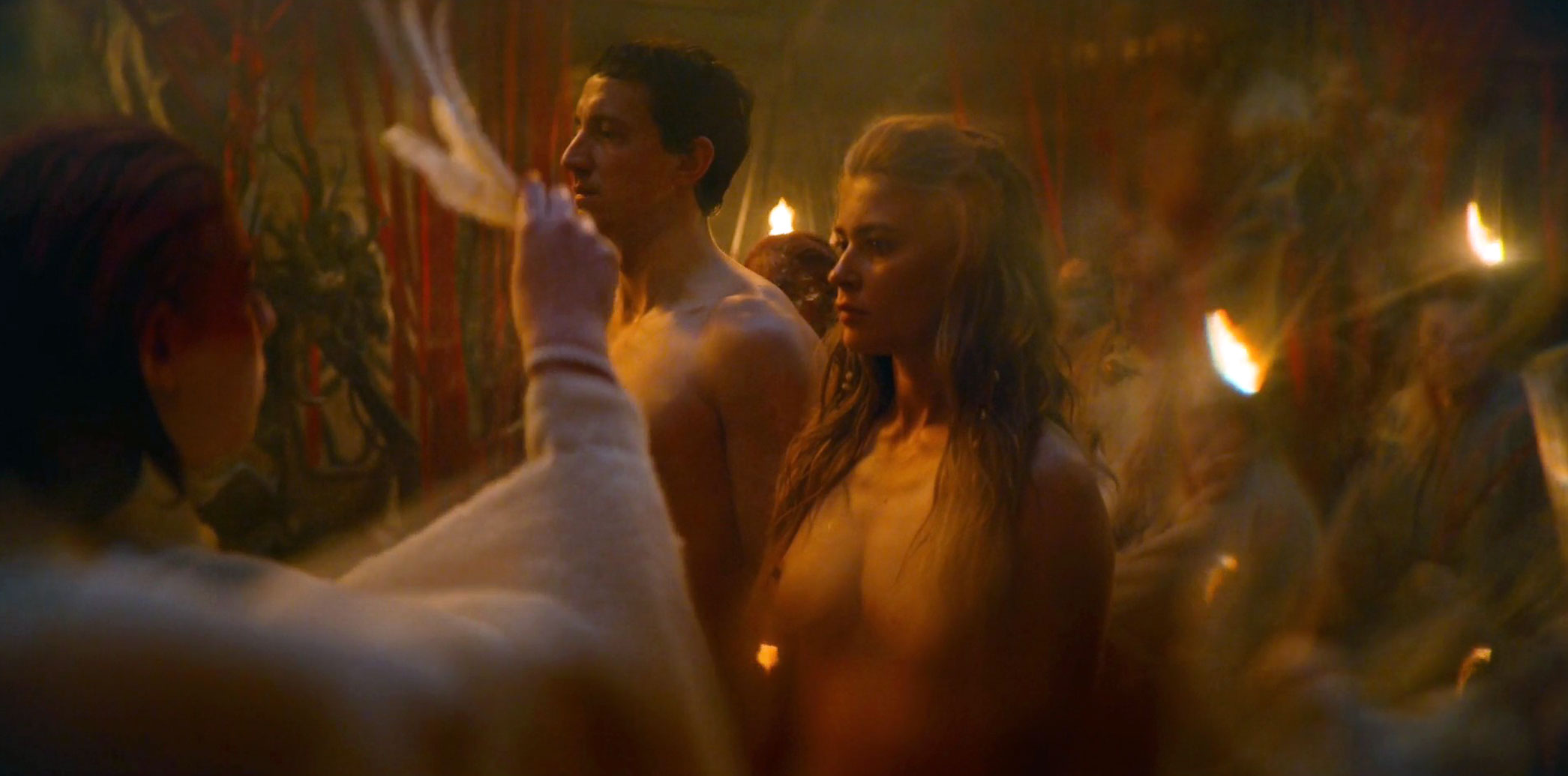 We see Jeanne Goursaud standing topless beside a man in this scene. 