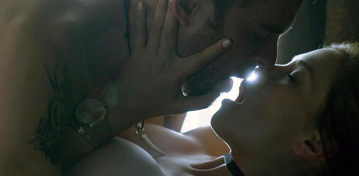 Carolina Miranda kisses a man before removing her sweater and bra and revea...